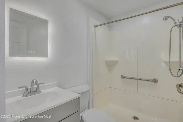 a bathroom with a sink toilet and shower