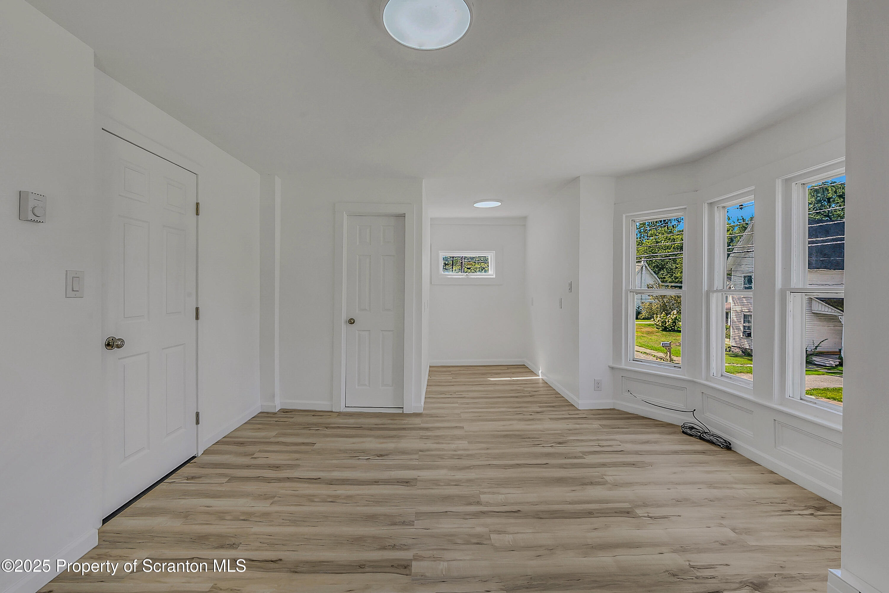 218 East Main Street Susquehanna, PA 18847 - Photo 26 of 43 a view of an empty room with window and wooden floor