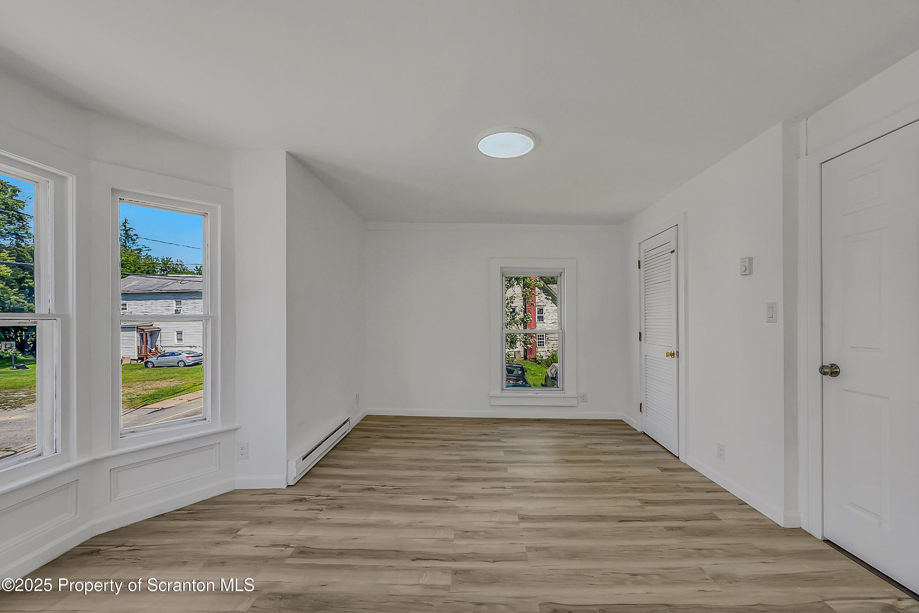 218 East Main Street Susquehanna, PA 18847 - Photo 27 of 43 a view of an empty room with window and wooden floor