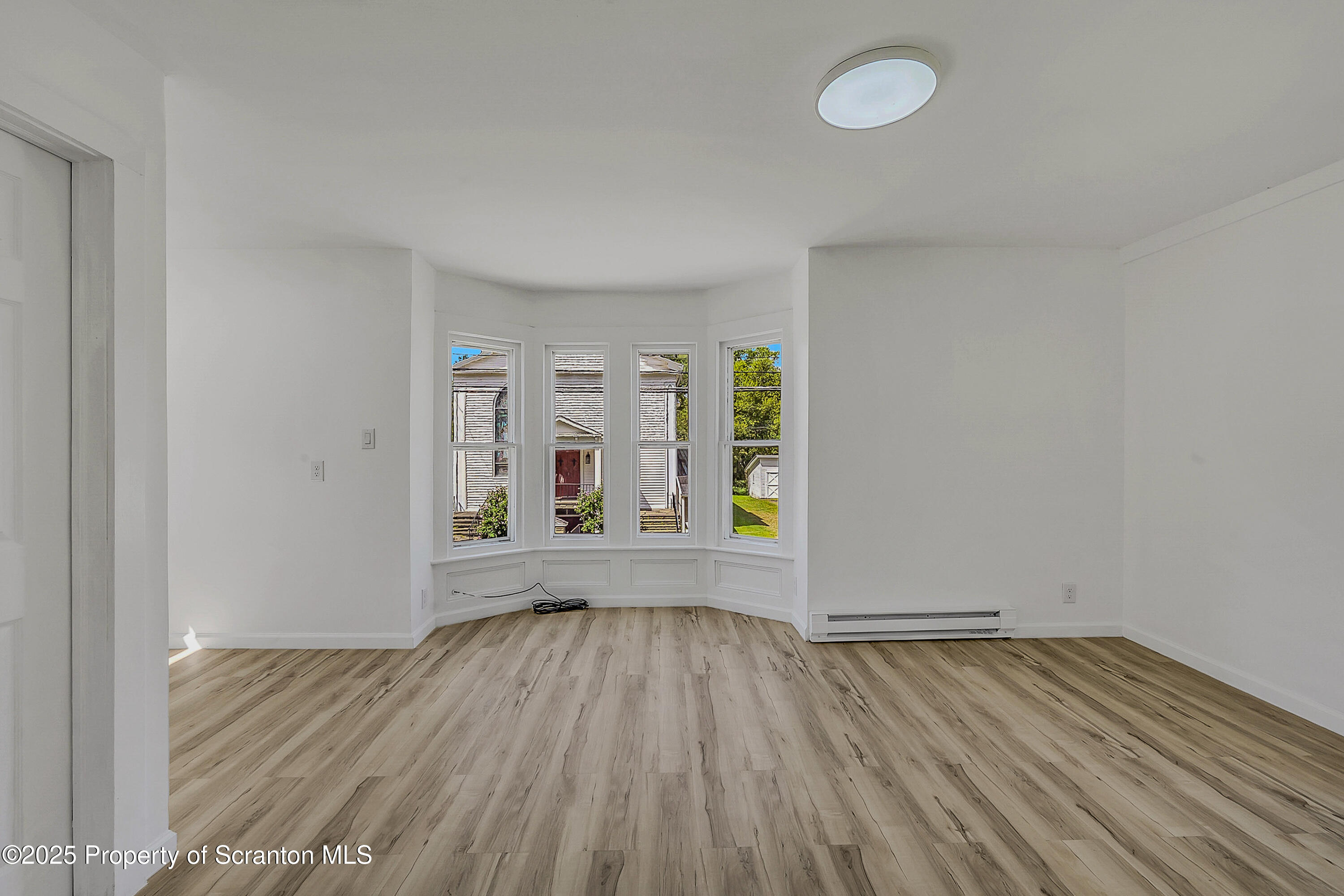 218 East Main Street Susquehanna, PA 18847 - Photo 28 of 43 an empty room with wooden floor and windows