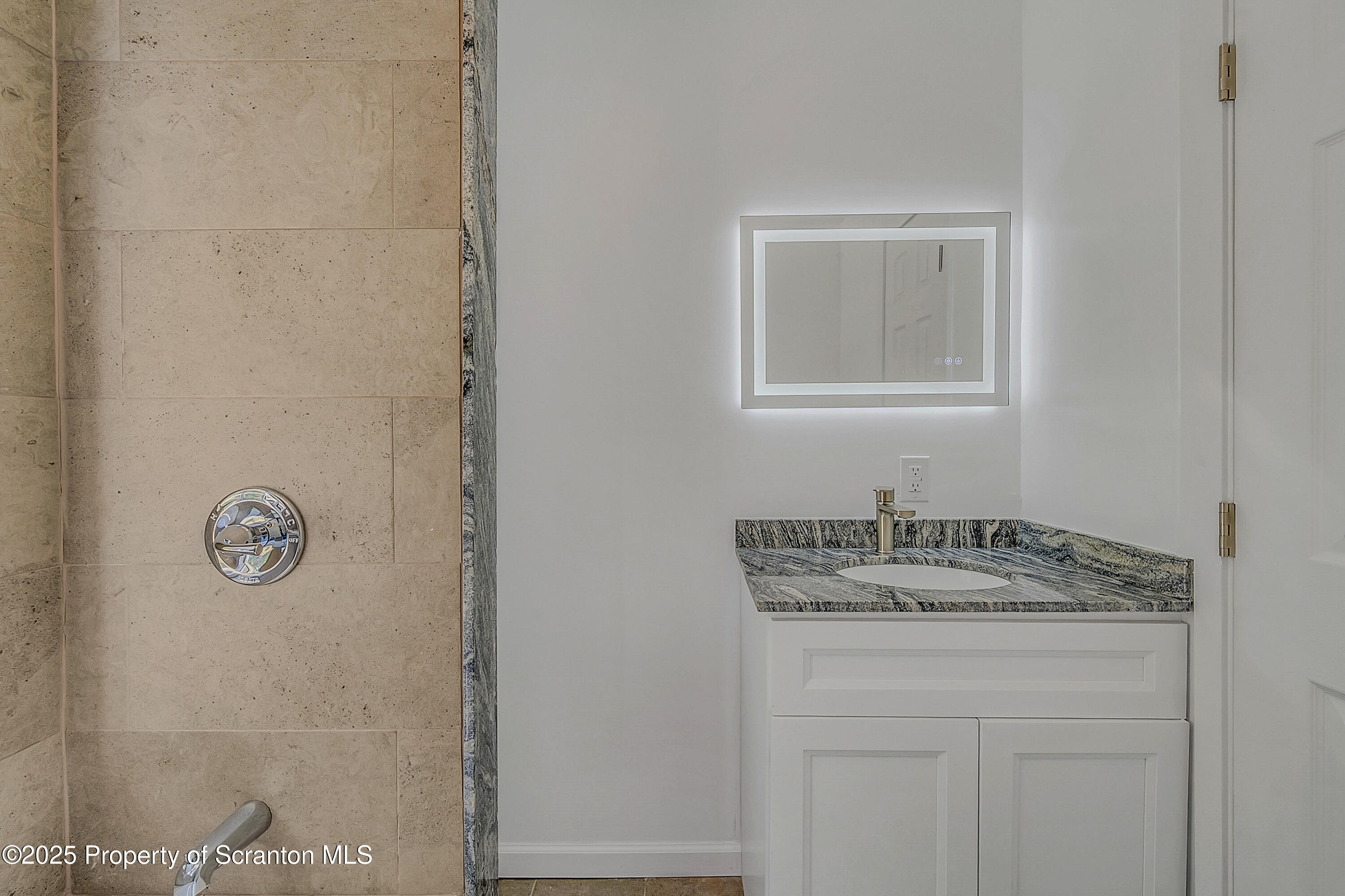 218 East Main Street Susquehanna, PA 18847 - Photo 31 of 43 a bathroom with a granite countertop sink and a mirror