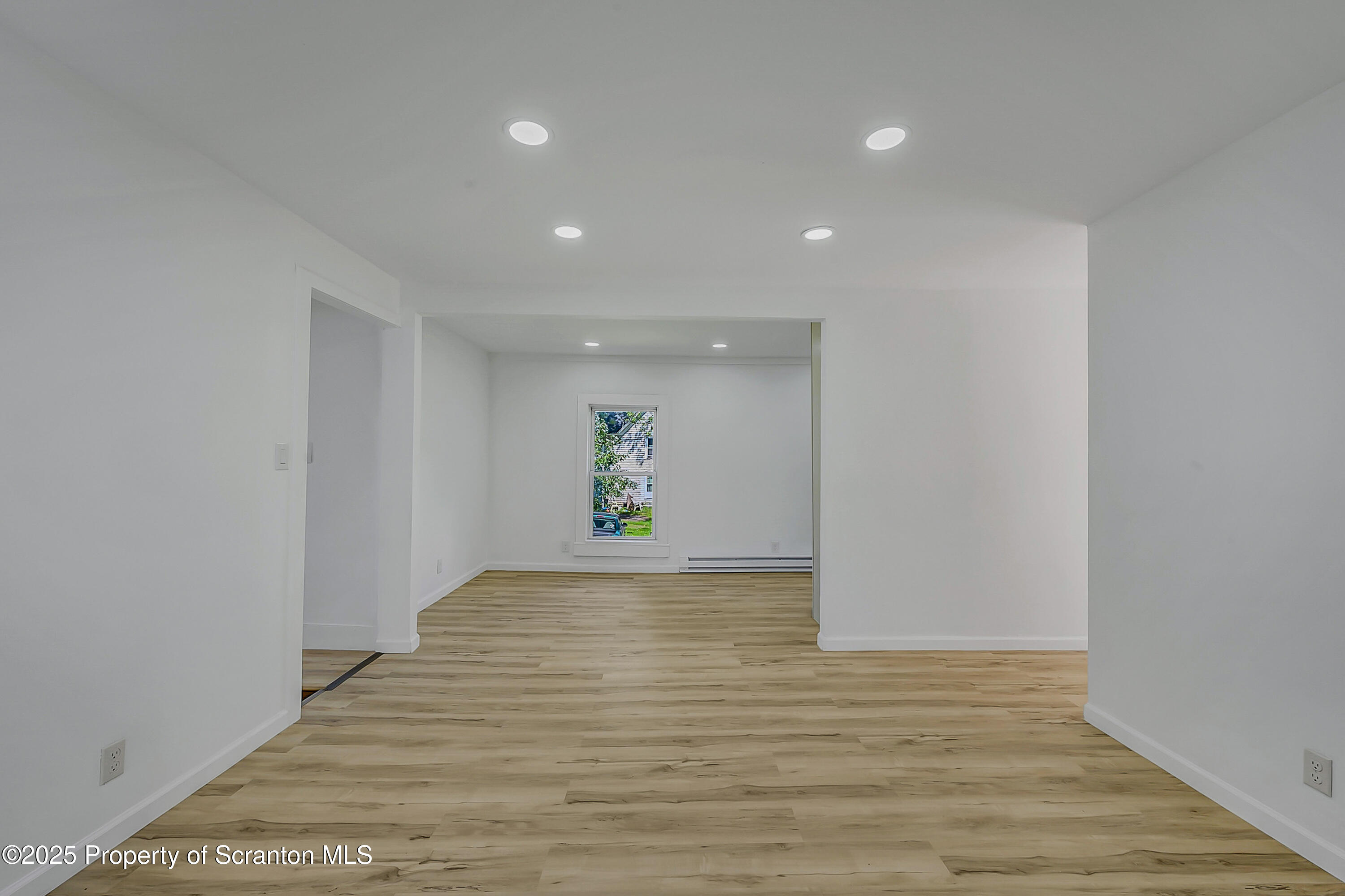 218 East Main Street Susquehanna, PA 18847 - Photo 34 of 43 a view of an empty room with wooden floor and window