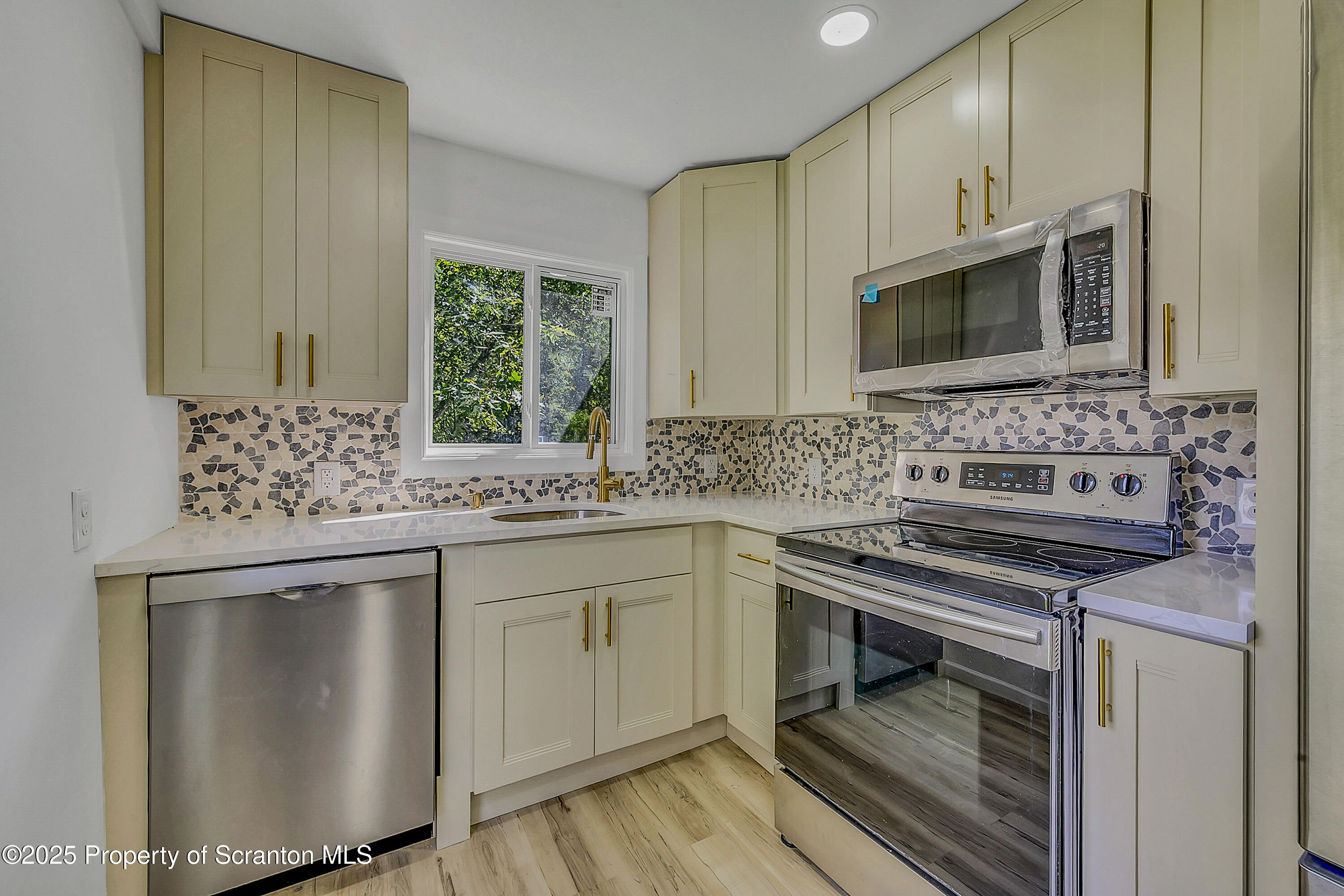 218 East Main Street Susquehanna, PA 18847 - Photo 38 of 43 a kitchen with stainless steel appliances a sink stove and cabinets