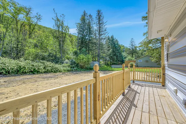 a view of a balcony with wooden floor