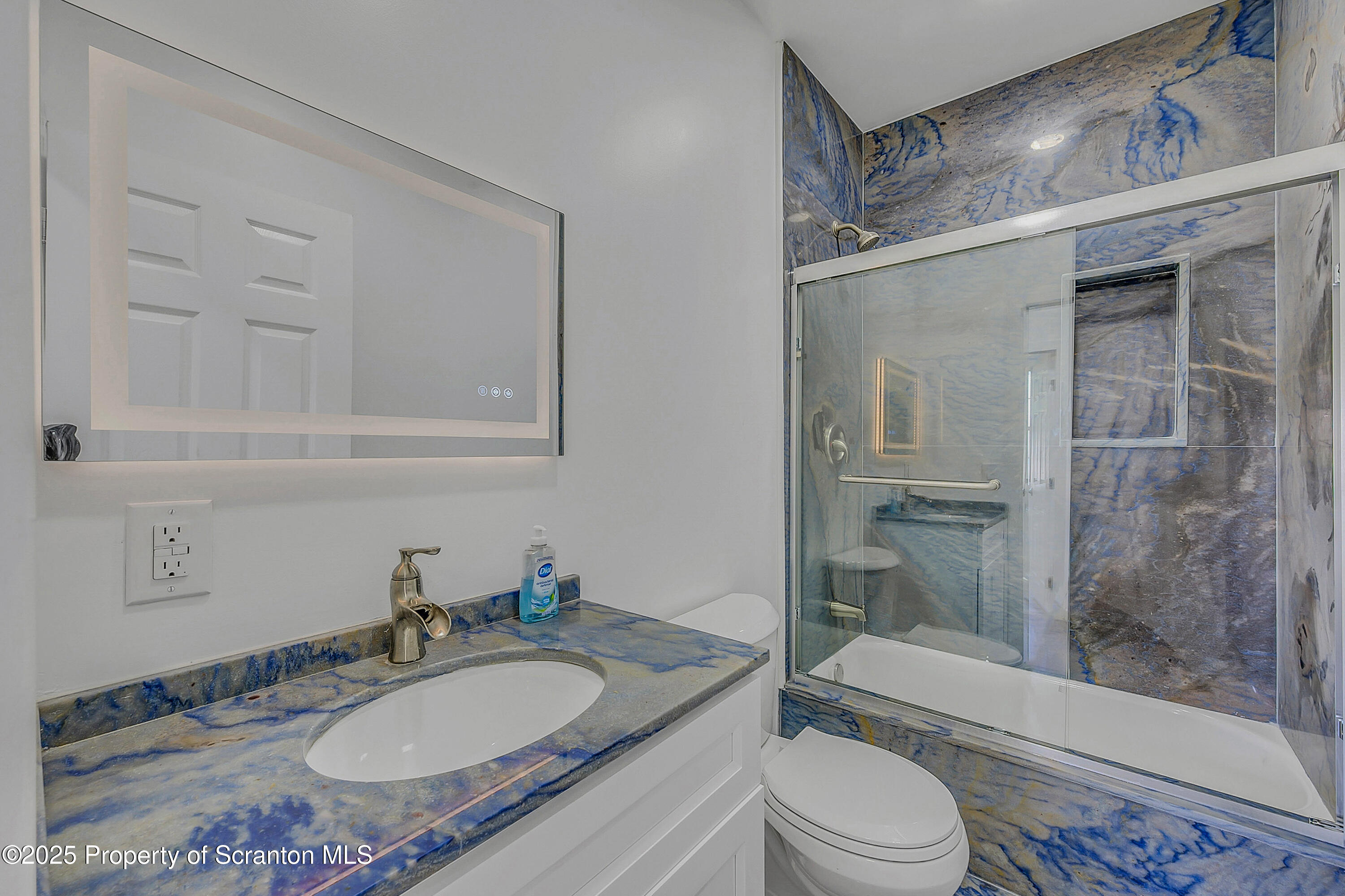 218 East Main Street Susquehanna, PA 18847 - Photo 10 of 43 a bathroom with a granite countertop sink toilet a mirror and shower