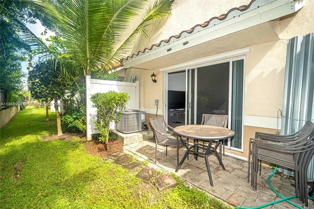 a view of a two chairs in the patio