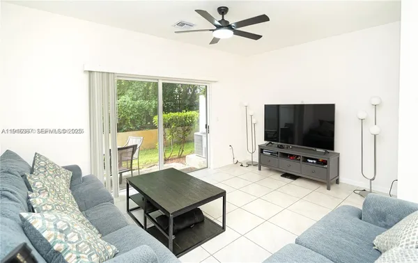 a living room with furniture and a flat screen tv