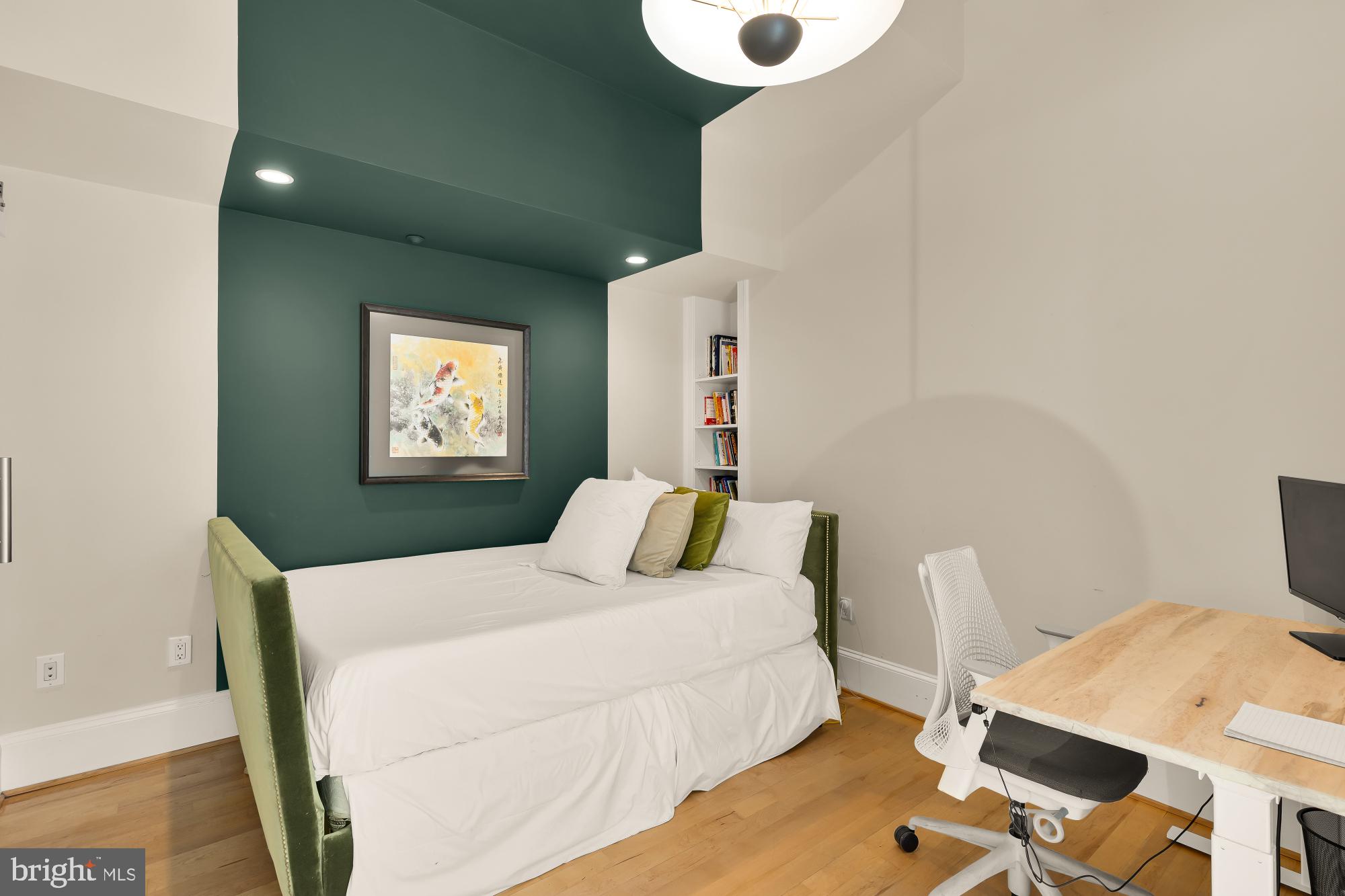 1220 N Street Northwest, Unit 4B Washington, DC 20005 - Photo 15 of 25 a bedroom with a bed and a table in it