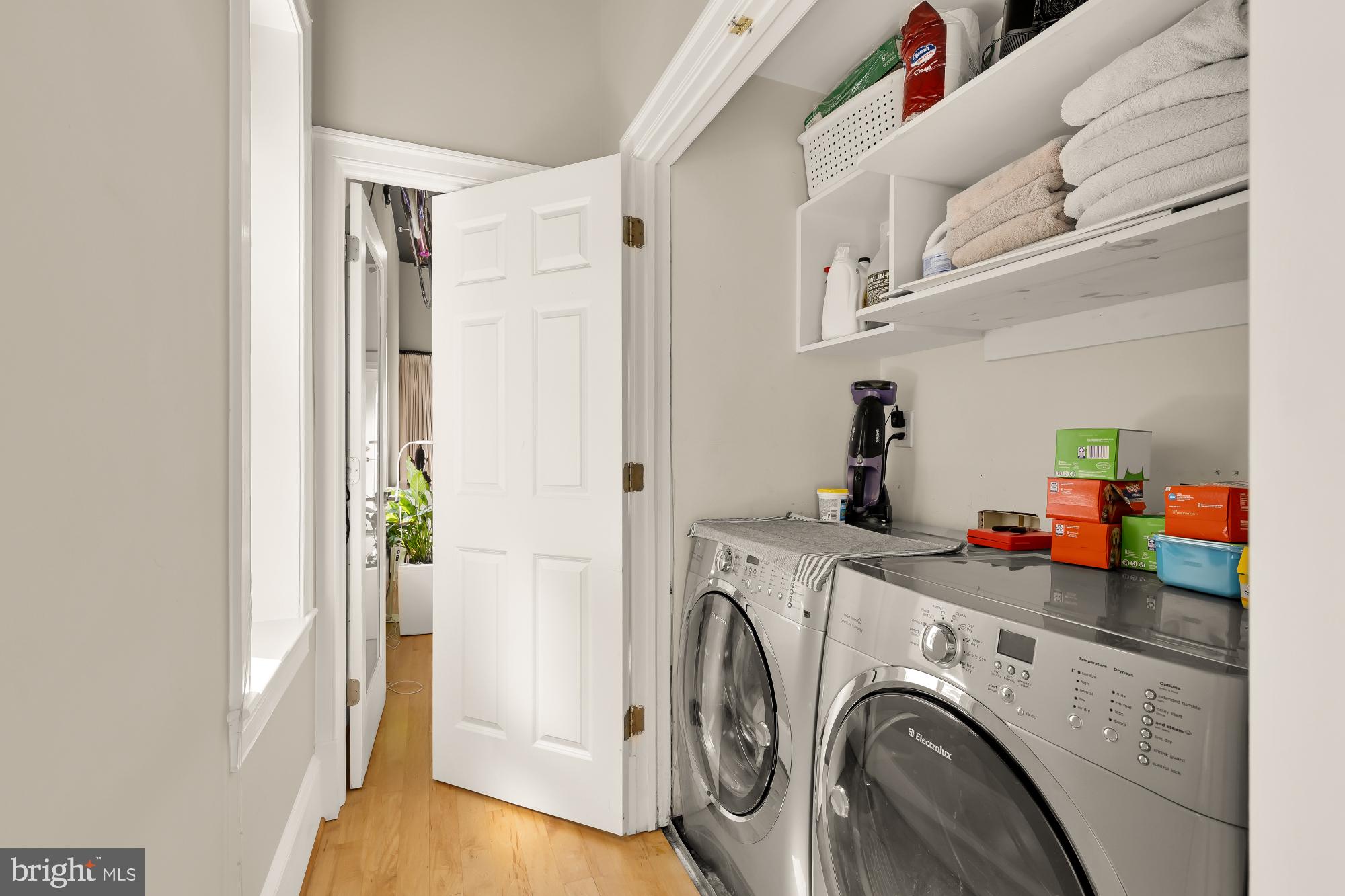 1220 N Street Northwest, Unit 4B Washington, DC 20005 - Photo 18 of 25 a view of washer and dryer with kitchen in the background