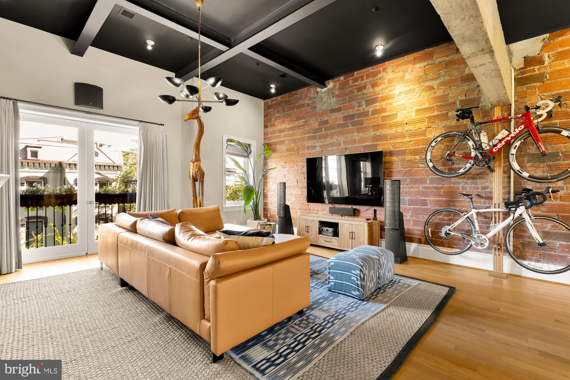 1220 N Street Northwest, Unit 4B Washington, DC 20005 - Photo 4 of 25 a living room with furniture and a flat screen tv