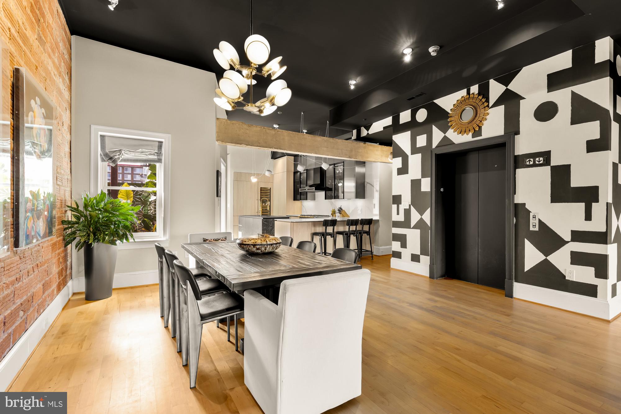 1220 N Street Northwest, Unit 4B Washington, DC 20005 - Photo 7 of 25 a dining room with wooden floor a chandelier a wooden table and chairs