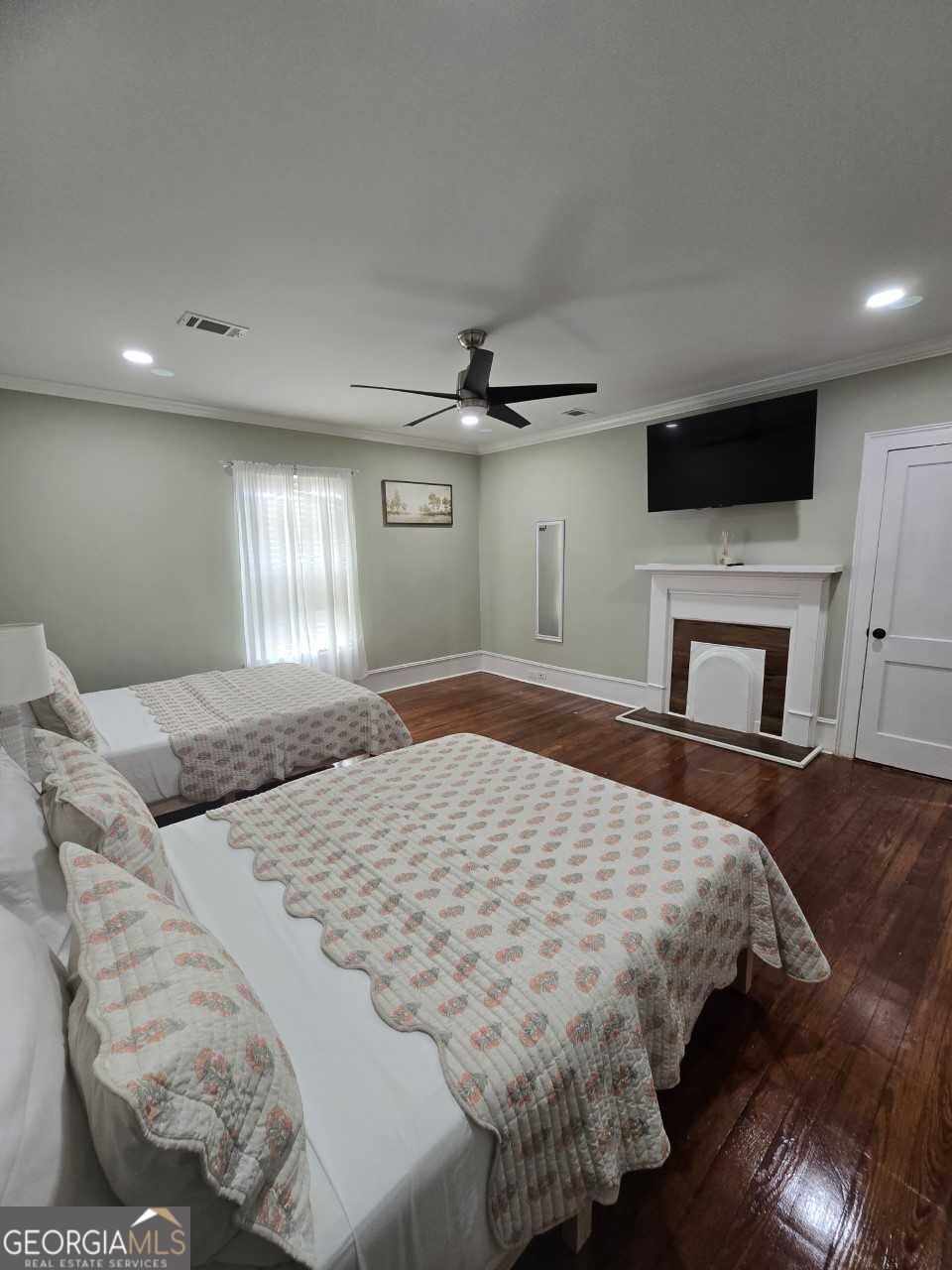 402 Meriwether Street Griffin, GA 30224 - Photo 17 of 36 a bedroom with a large bed and a tv