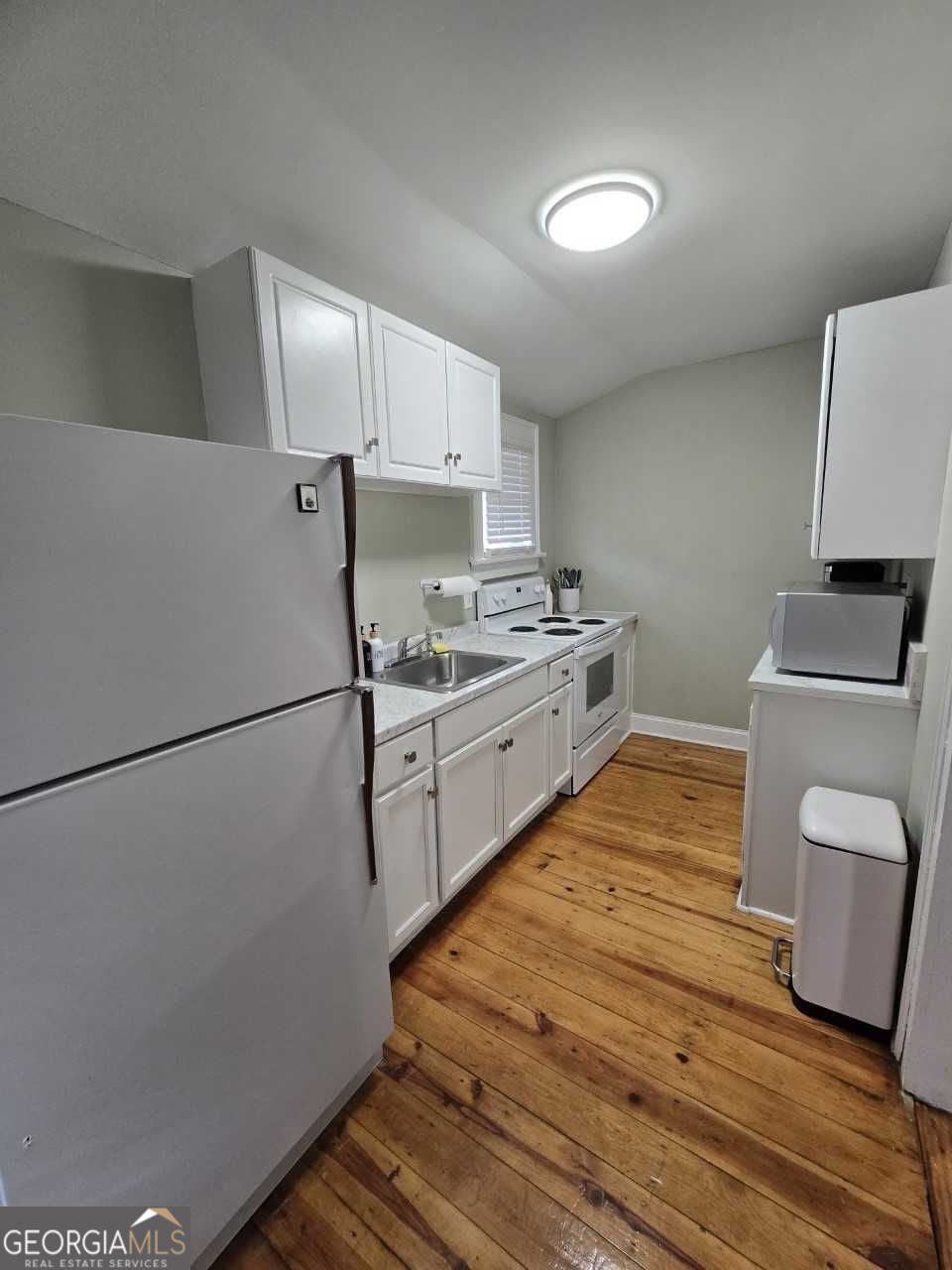 402 Meriwether Street Griffin, GA 30224 - Photo 23 of 36 a kitchen with a sink appliances and cabinets