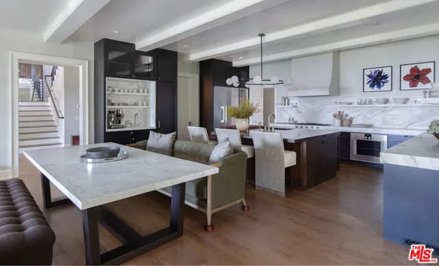 a dining room with furniture and a large window