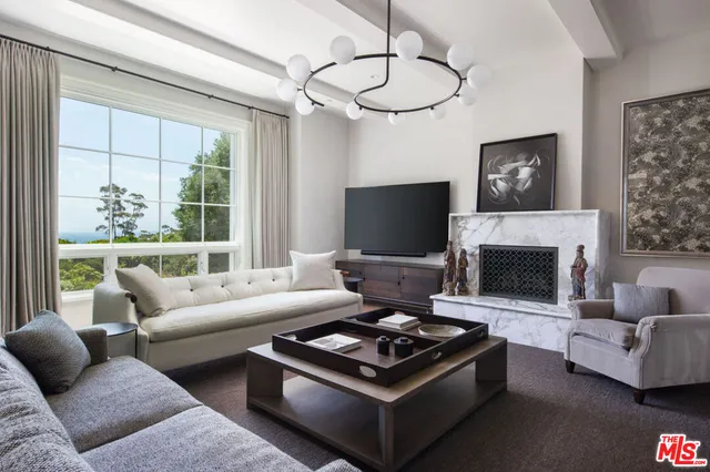 a view of a porch with furniture and wooden floor