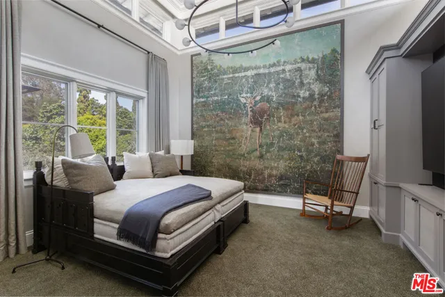 a bedroom with a bed and a chandelier