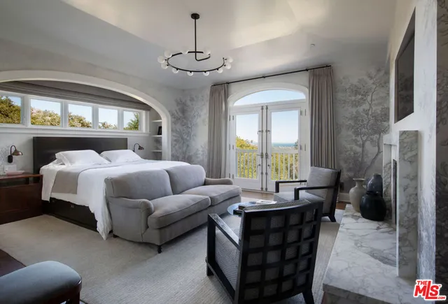 a bedroom with furniture and a fireplace