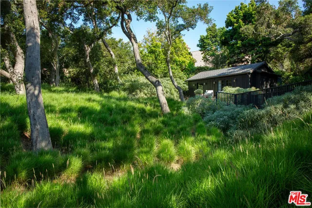 a view of house with backyard and seating space