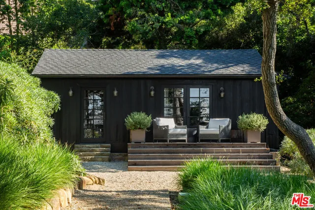 a living room with furniture potted plant and a window