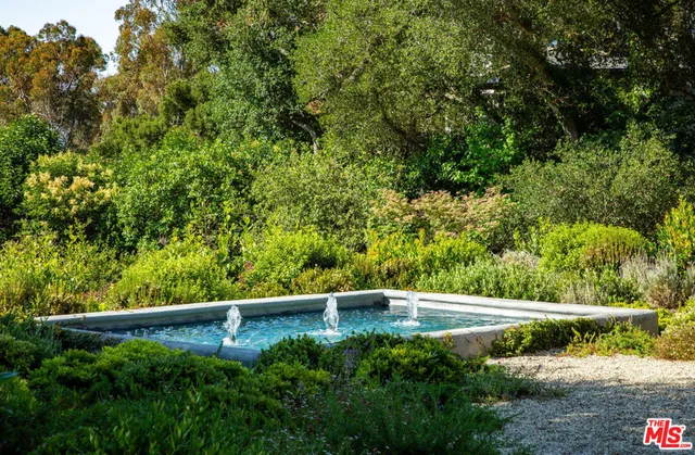 a living room with furniture a chandelier and a fireplace