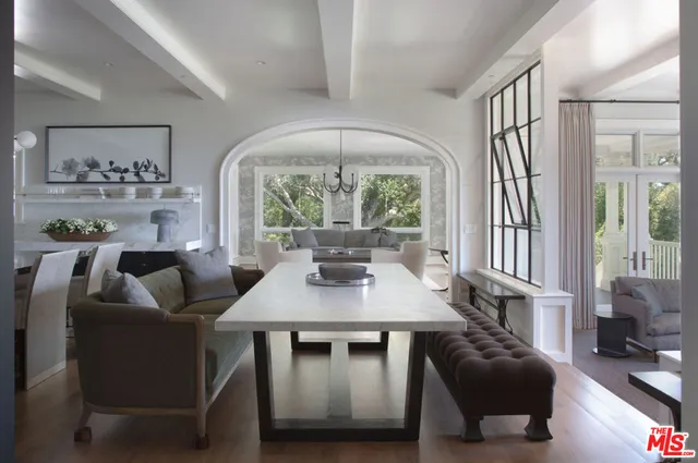 a kitchen with granite countertop a sink stove and wooden floor