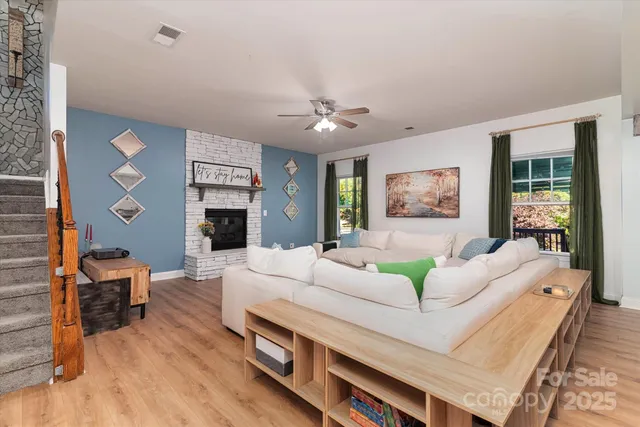 a living room with furniture and kitchen view