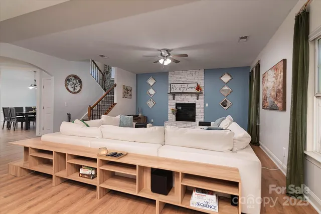 a kitchen with stainless steel appliances kitchen island granite countertop a stove a sink and a refrigerator