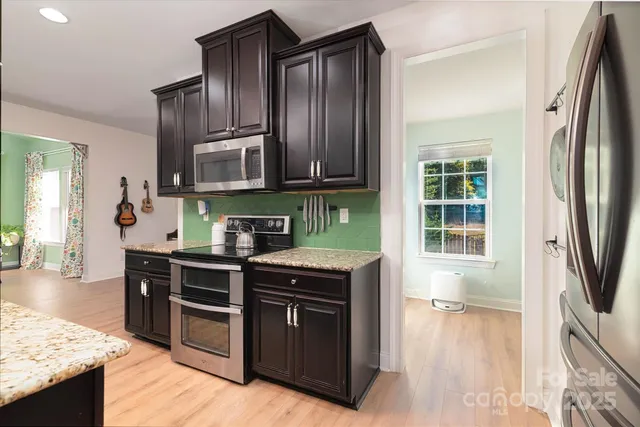 a view of a workspace with wooden floor and a potted plant