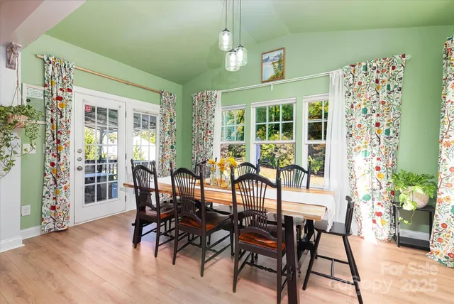 a view of a hallway with wooden floor and cabinet