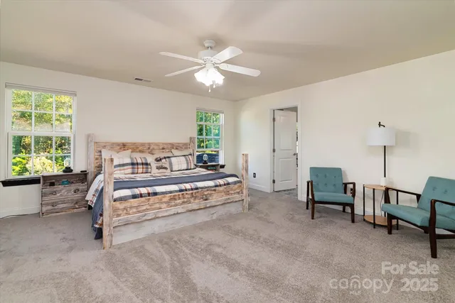 a bedroom with furniture and a chandelier