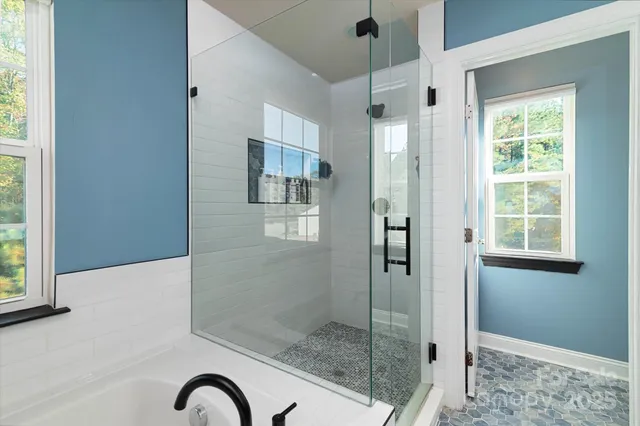 a en suite bathroom with a tub sink and window