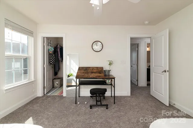 a bedroom with bed and a chandelier