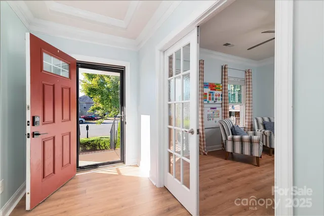 a living room with furniture and a floor to ceiling window