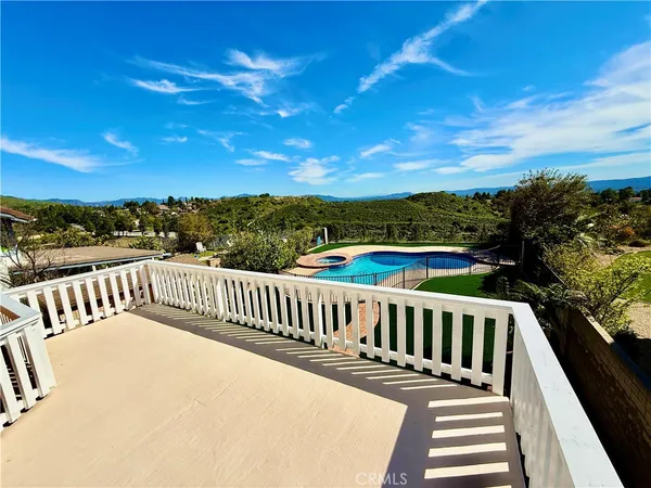 a view of a balcony with wooden floor and city view