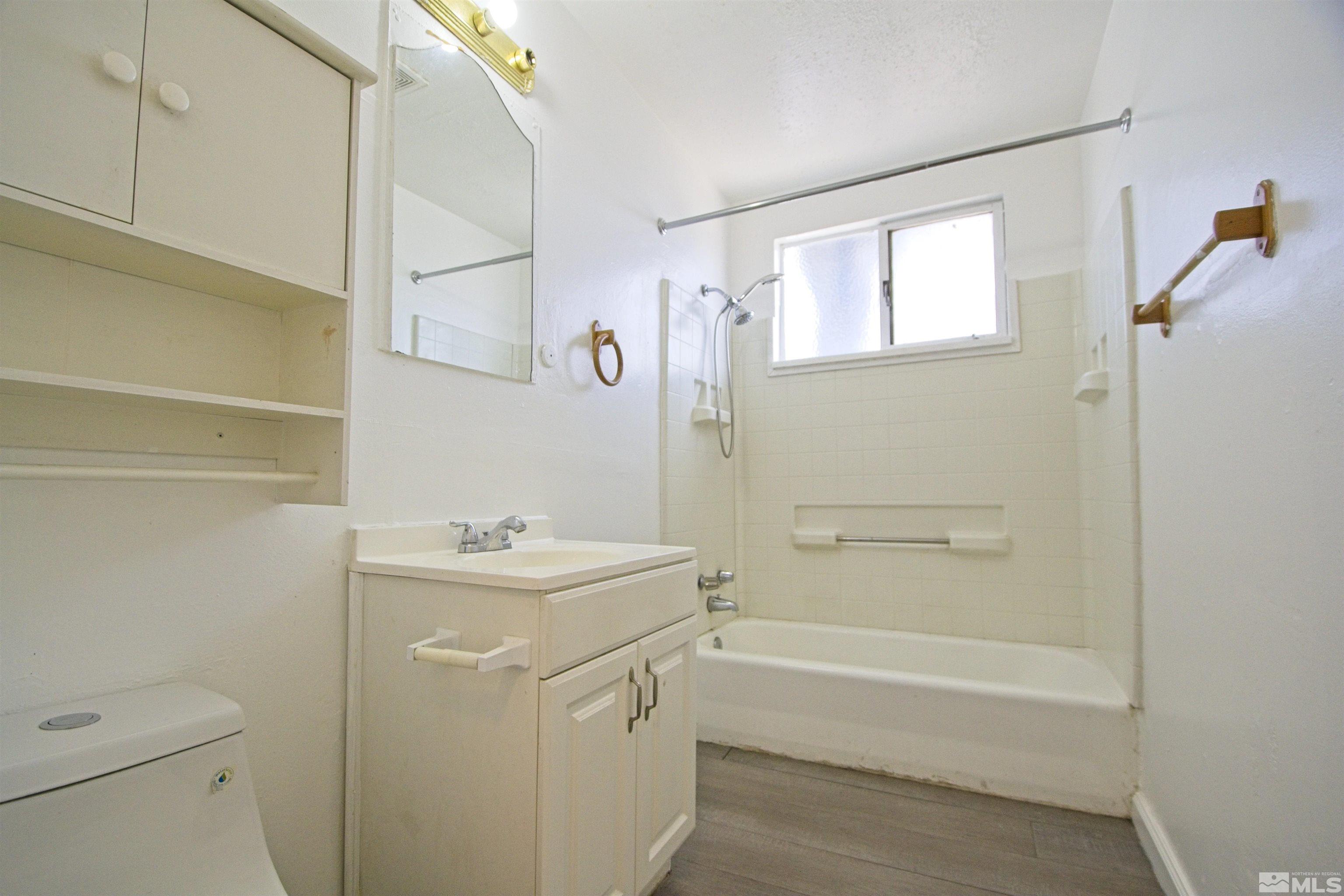 2516 D Street Sparks, NV 89431 - Photo 7 of 9 a bathroom with a sink toilet vanity and tub