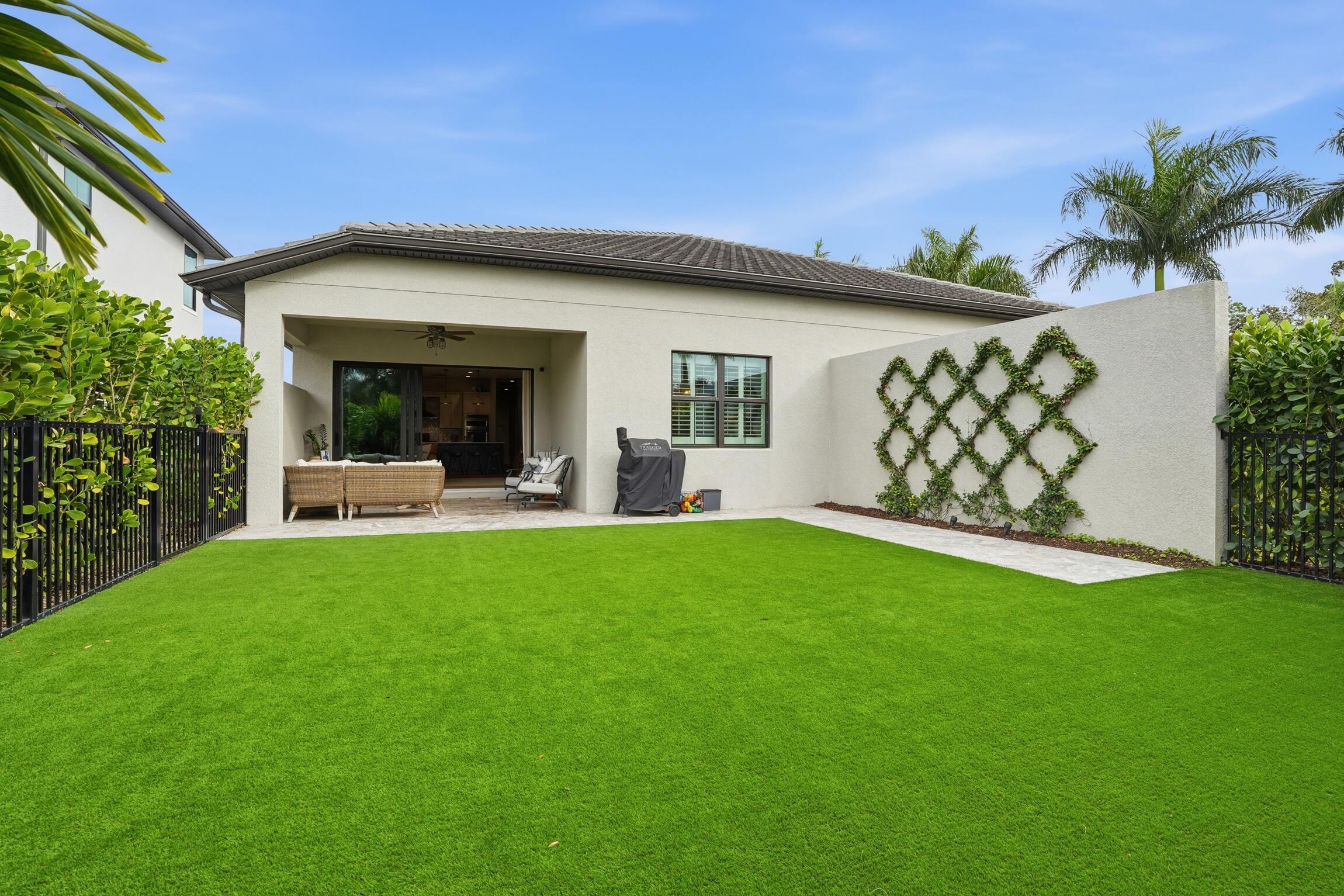 14708 Kingfisher Loop Naples, FL 34120 - Photo 36 of 42 a view of a house with backyard and a garden