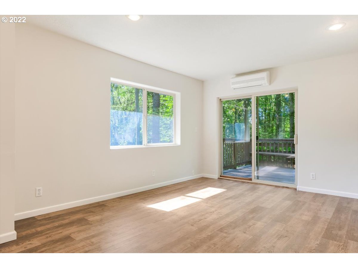 15727 Northwest Sheltered Nook Road Portland, OR 97231 - Photo 10 of 32 an empty room with large windows