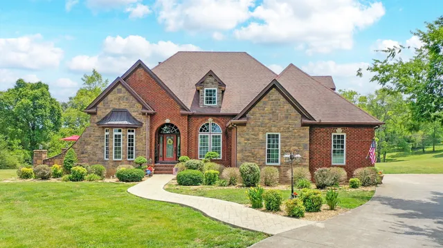a front view of a house with a yard and garage