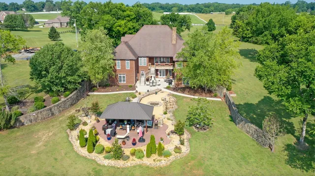 an aerial view of a house with yard swimming pool and outdoor seating