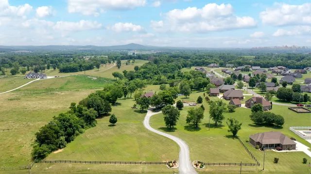 an aerial view of a house with a yard and lake view