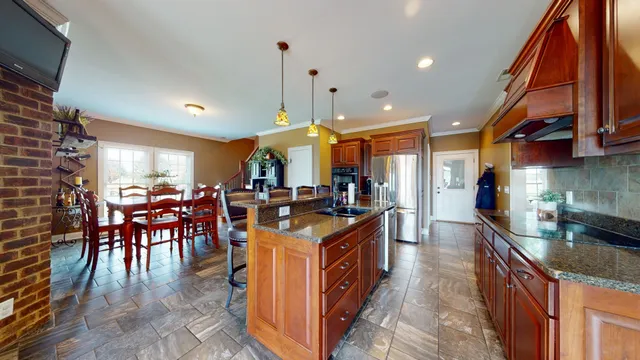 a large kitchen with a table and chairs