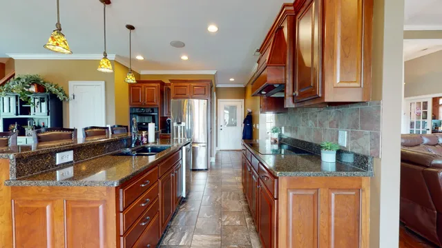 a kitchen with stainless steel appliances granite countertop a sink and stove