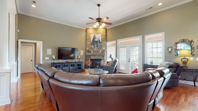 a living room with furniture and a floor to ceiling window