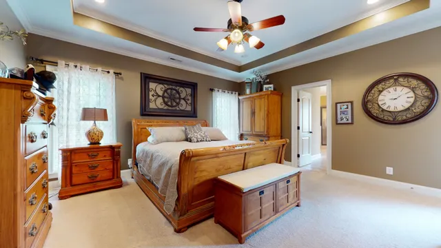 a bedroom with a bed and a chandelier