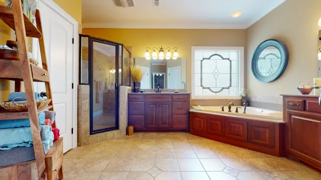 a large bathroom with a large tub and sink
