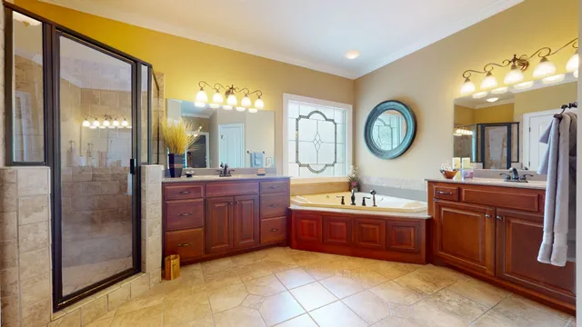 a bathroom with a granite countertop sink a mirror a vanity and a bathtub