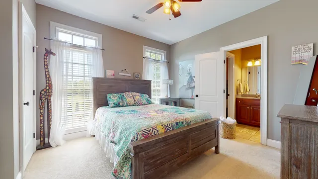 a bathroom with a toilet and a shower curtain