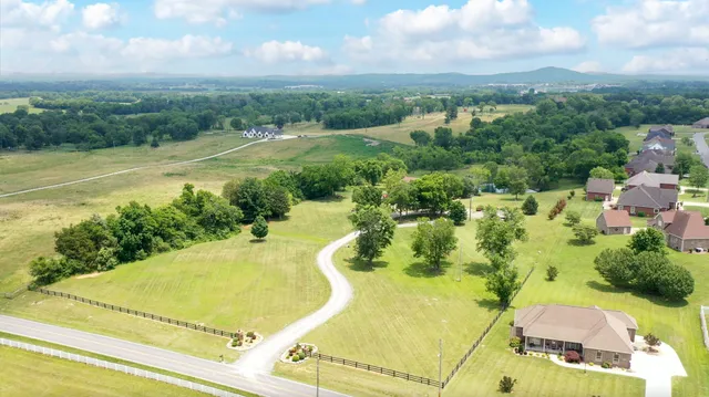 an aerial view of residential houses with outdoor space and swimming pool