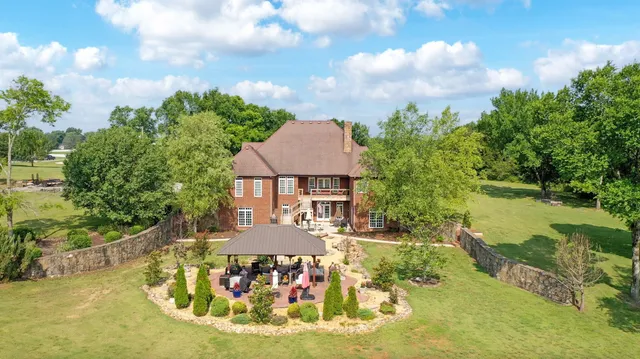 a view of a house with swimming pool and sitting area