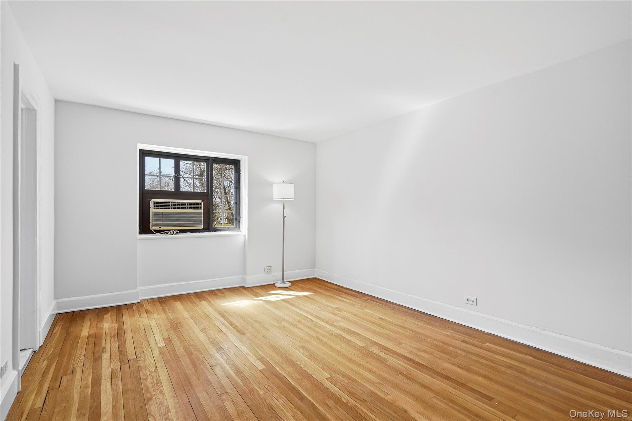 6 Davis Avenue, Unit C22 Rye, NY 10580 - Photo 14 of 20 Primary Bedroom has window that faces backyard of a house on Davis Avenue, away for the street
